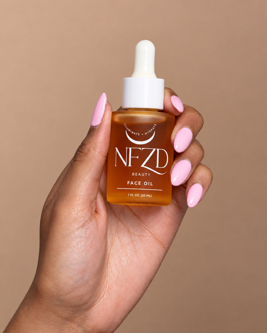 Hand holding NFZD Illuminate + Hydrate Face Oil